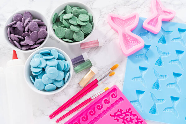 Flat lay. Ingredients to make chocolate mermaid molds from the chocolate chips.