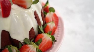 Çilekli kek ve beyaz tabakta nane şekeri.