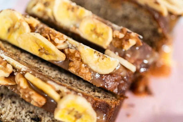 Sliced Loaf Banana Nut Bread Drizzled Homemade Caramel Pink Cutting — Stock Photo, Image