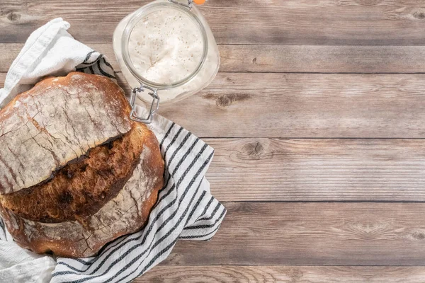 Flat lay. Freshly baked sourdough rye loaf of bread.