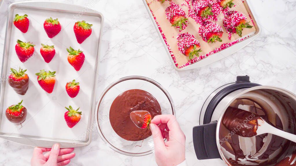 Flat lay. Step by step. Dipping organic strawberries into melted chocolate.