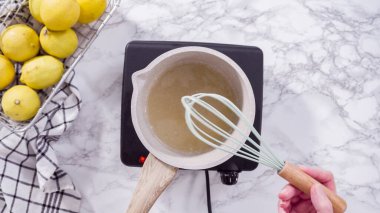 Adım adım. Düz yatıyordu. Bir tencerede kek sosu pişirmek..