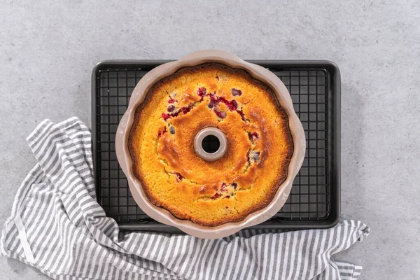 Flat lay. Freshly baked lemon cranberry bundt cake in a bundt cake pan.