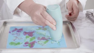 Vanilyalı kekleri süslemek için silikon kalıplı çikolata denizkızı kuyruğu yapıyorum..