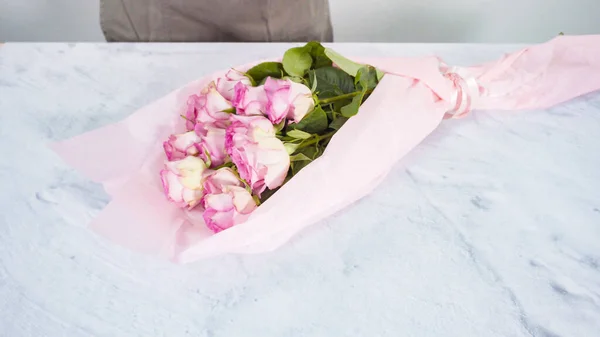 一歩ずつ ピンクのバラから花束を手配する花屋 — ストック写真