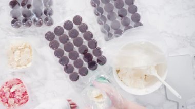 İtalyan tereyağı kremalı çikolatalı mini kekler. Parlak çikolatalı kar taneleriyle süslenmiş..