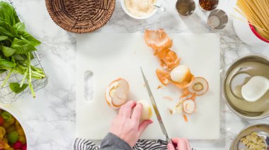 Düz yatıyordu. Adım adım. Tek demlik makarna tarifi yapmak için beyaz bir kesim tahtasıyla sebze kesmek..