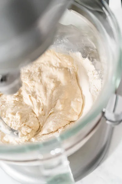 Mixing bread dough in a stand-alone kitchen mixer to bake patriotic cinnamon twists.