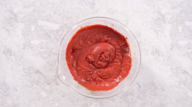 Düz yatıyordu. Adım adım. Kırmızı kadife kek hazırlamak için karıştırma kabındaki malzemeleri karıştırıyorum..