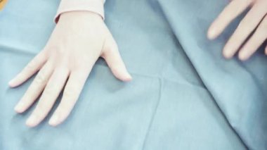 Koronavirüs salgını için dikiş makinesiyle pamuk yüz maskesi dikiyorum..