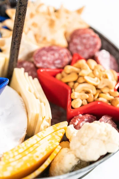 チーズ クラッカー サラミ 新鮮な果物でいっぱいの2層の金属製のスタンドに7月4日のシャルキュトリボード — ストック写真