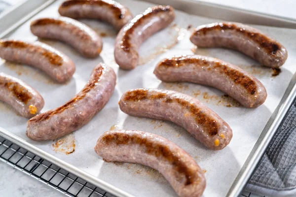 Freshly Cooked Oven Beer Bratwursts Baking Sheet Lined Parchment Paper — Stock Photo, Image