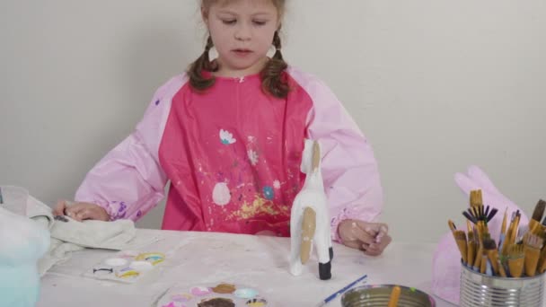 Homeschooling Covid Lockdown Little Girl Painting Paper Mache Easter Bunny — Stock Video