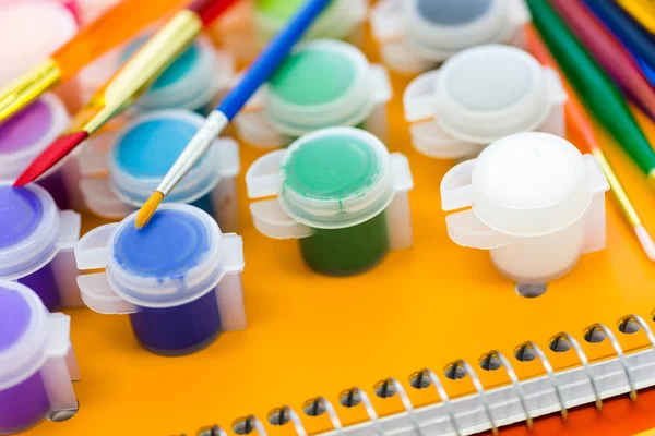 Paints, brushes and notebooks School supplies — Stock Photo, Image