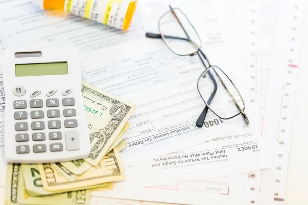 Калькулятор, наличные и очки - налоговая декларация — стоковое фото