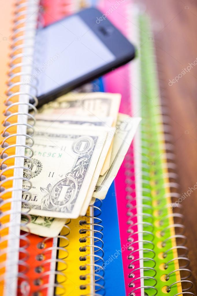 Phone, dollars and notebooks, School supplies