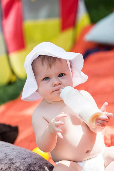 Cute baby girl with bottle of milk — Stock Photo, Image