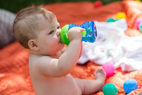 Cute baby drinking from bottle — Stock Photo, Image