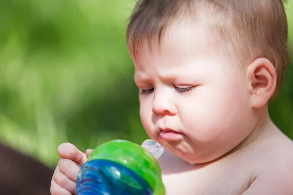 Cute baby drinking from bottle — Stock Photo, Image