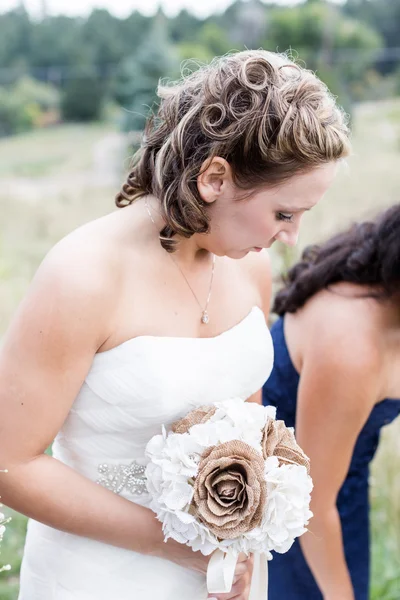 Bride holding wedding bouquet — Stock Photo, Image