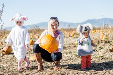 Mother with kids in Halloween Costumes clipart