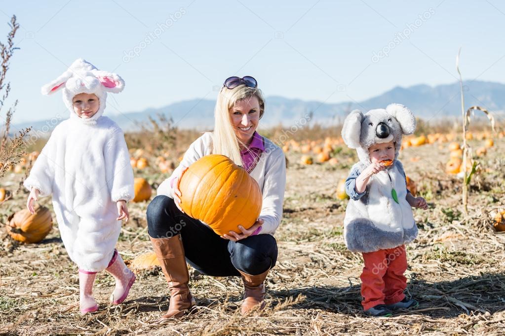 Mother with kids in Halloween Costumes