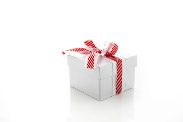 Box with red and white ribbon — Stock Photo, Image