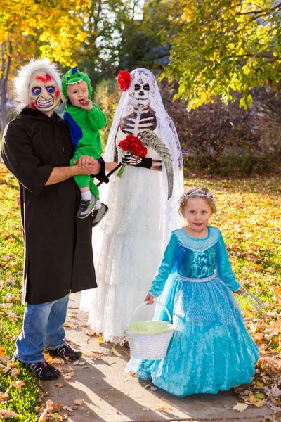 Family in costumes on Halloween night — Stock Photo, Image