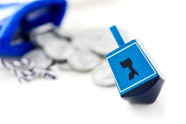 Blue dreidel with silver tokens clipart