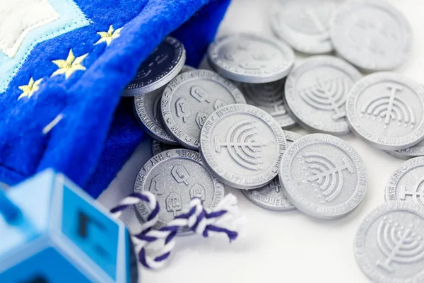 Blue dreidel with silver tokens — Stock Photo, Image
