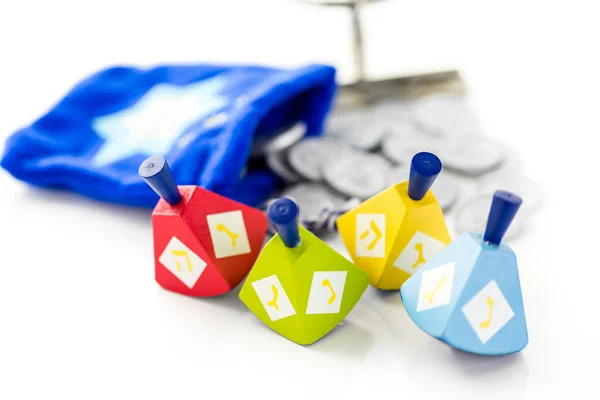 Colorful dreidels with silver tokens, Hanukkah — Stock Photo, Image