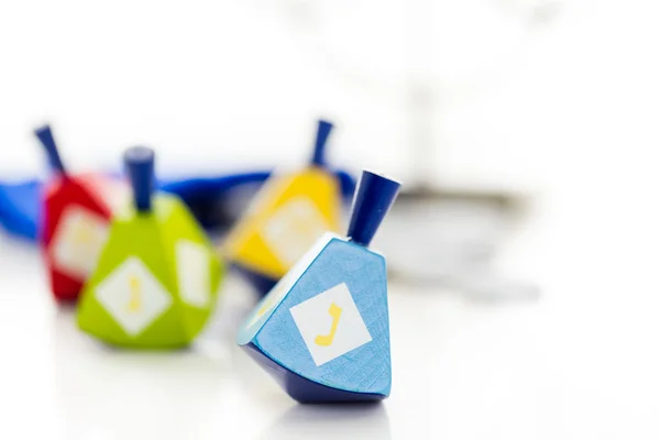 Colorful dreidels with silver tokens, Hanukkah — Stock Photo, Image