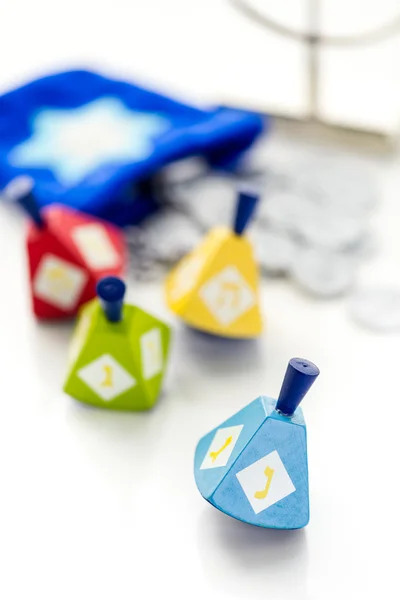 Colorful dreidels with silver tokens, Hanukkah — Stock Photo, Image