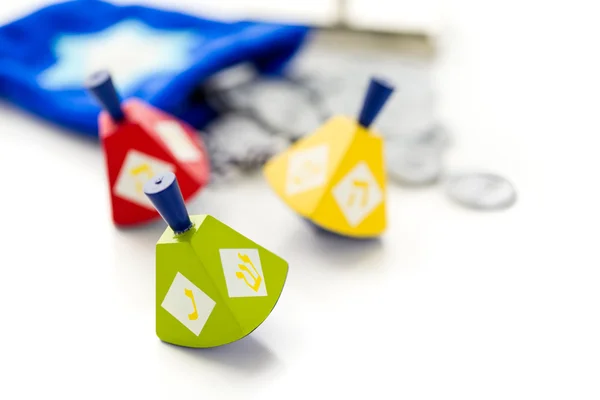 Colorful dreidels with silver tokens, Hanukkah — Stock Photo, Image