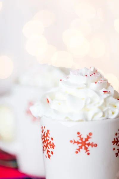 Hot chocolate with whipped cream and crashed peppermint candies — Stock Photo, Image