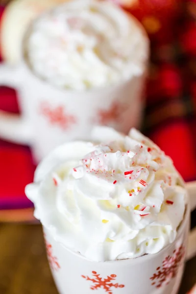 Hot chocolate with whipped cream and crashed peppermint candies — Stock Photo, Image