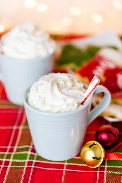Hot chocolate with whipped cream and peppermint stirrer — Stock Photo, Image