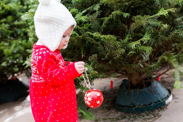 Cute baby girl in red Scandinavian dress — Stock Photo, Image