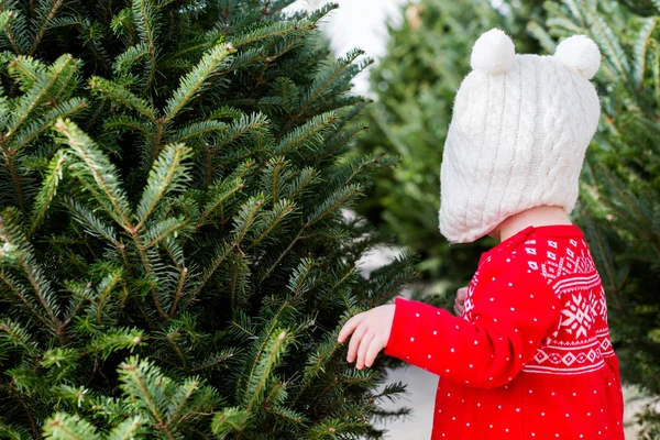 Cute baby girl in red Scandinavian dress — Stock Photo, Image