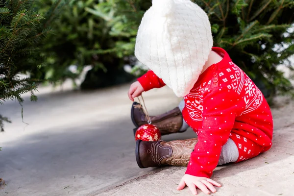 Cute baby girl in red Scandinavian dress — Stock Photo, Image