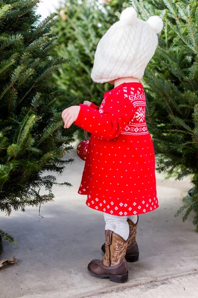 Cute baby girl in red Scandinavian dress — Stock Photo, Image