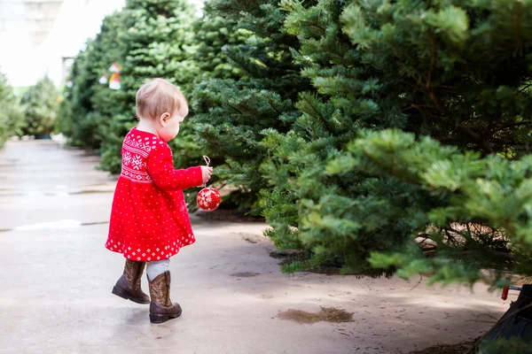 Cute baby girl in red Scandinavian dress — Stock Photo, Image