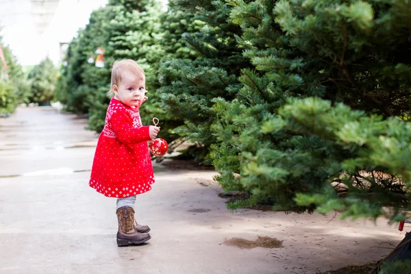 Cute baby girl in red Scandinavian dress — Stock Photo, Image