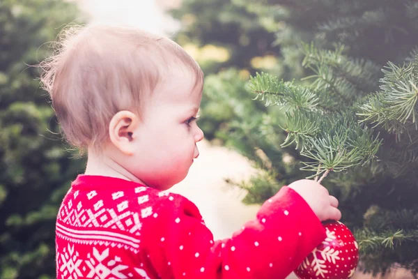 Cute baby girl in red Scandinavian dress — Stock Photo, Image