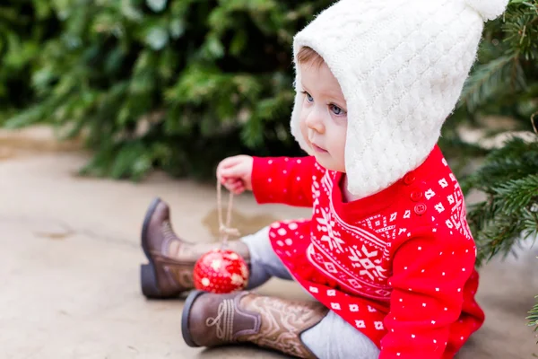 Cute baby girl in red Scandinavian dress — Stock Photo, Image