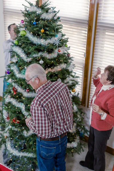 Family decorating Christmas tree — Stock Photo, Image