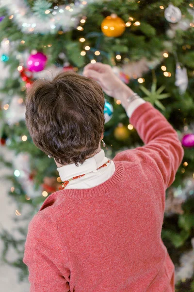 Grandmother decorating Christmas tree — Stock Photo, Image