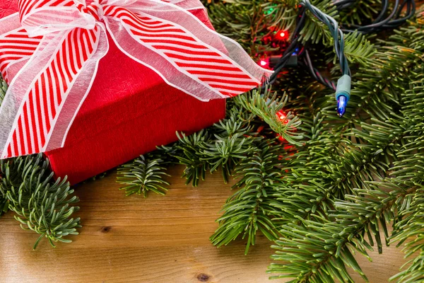 Christmas Present and tree branches — Stock Photo, Image