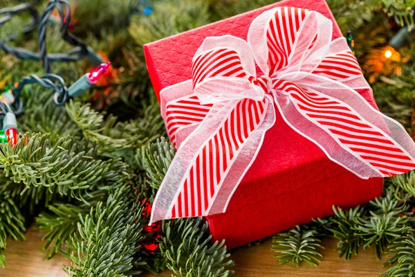 Christmas Present and tree branches — Stock Photo, Image
