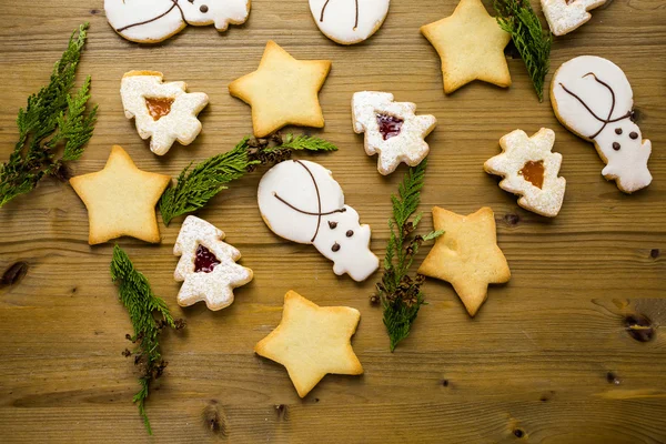 Sugar cookies in shape of snowman, stars, and christmas tree